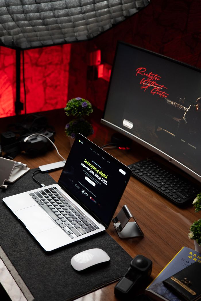 Crafting Captivating Headlines: Your awesome post title goes here Stylish office setup featuring a laptop and monitor on a wooden desk with ambient lighting.